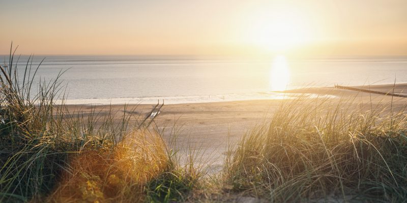 View to the beach at a summer sunset. ideal for websites and magazines layouts